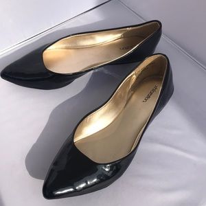 Black faux paten leather flats.